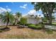 Charming single-story home with manicured landscaping, palm trees and an attached two-car garage at 799 Harrington Lake N Dr # 73, Venice, FL 34293