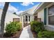 Inviting walkway leading to the front door with lush greenery and decorative features at 799 Harrington Lake N Dr # 73, Venice, FL 34293