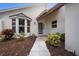 Warm and inviting front entrance with a bay window, well-kept landscaping, and a charming pathway at 799 Harrington Lake N Dr # 73, Venice, FL 34293