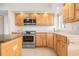Kitchen featuring stainless steel appliances, granite countertops, and light wood cabinets at 799 Harrington Lake N Dr # 73, Venice, FL 34293