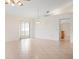 Bright, open living room featuring tile flooring, sliding glass doors, and ample natural light at 799 Harrington Lake N Dr # 73, Venice, FL 34293
