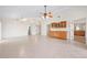 Spacious living room featuring tile floors, ceiling fan, and built in cabinets at 799 Harrington Lake N Dr # 73, Venice, FL 34293