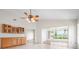 An inviting living space with tile floors, built-in cabinets, and a ceiling fan, all bathed in natural light at 799 Harrington Lake N Dr # 73, Venice, FL 34293