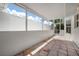 This tiled patio features a view of a garden space and plenty of natural light at 799 Harrington Lake N Dr # 73, Venice, FL 34293
