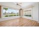 Bright sun room with wood floors, large windows offering a lake view and lots of natural light at 799 Harrington Lake N Dr # 73, Venice, FL 34293