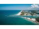 Beautiful aerial view of the coastline with clear blue water, sandy beaches, and the city nearby on a sunny day at 810 Capri Isles Blvd # 230, Venice, FL 34292