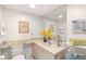 Bright bathroom with a vanity, mirror, decorative accents, and a convenient toilet and towel rack at 810 Capri Isles Blvd # 230, Venice, FL 34292