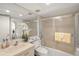 Bathroom featuring a vanity, toilet, and glass-enclosed shower, complete with neutral decor and updated fixtures at 810 Capri Isles Blvd # 230, Venice, FL 34292