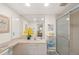 Bathroom with a mirrored vanity, shower and additional storage space at 810 Capri Isles Blvd # 230, Venice, FL 34292