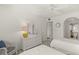 Well-lit bedroom with twin beds, white furniture and bathroom access at 810 Capri Isles Blvd # 230, Venice, FL 34292
