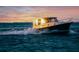 Stylish boat sailing on the water during a golden sunset, highlighting luxury and adventure at 810 Capri Isles Blvd # 230, Venice, FL 34292