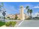 The Venice Theatre building featuring a tall beige tower and well maintained landscaping. Tampa Ave street sign in image at 810 Capri Isles Blvd # 230, Venice, FL 34292