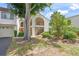 Attractive building exterior showcasing open stairways, lush landscaping, and large shade tree at 810 Capri Isles Blvd # 230, Venice, FL 34292