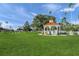 Inviting park gazebo surrounded by lush green grass and towering palm trees, perfect for relaxing or picnics at 810 Capri Isles Blvd # 230, Venice, FL 34292