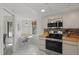 Charming kitchen nook featuring a small table, white appliances, and ample natural light at 810 Capri Isles Blvd # 230, Venice, FL 34292