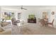 Spacious living area with multiple windows, comfortable seating, and a dining area for easy entertaining at 810 Capri Isles Blvd # 230, Venice, FL 34292
