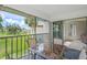 Cozy patio with views of the landscaped grounds and serene pond, perfect for relaxation at 810 Capri Isles Blvd # 230, Venice, FL 34292