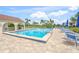 Refreshing community pool with ample seating, palm trees, and a beautiful view of the surrounding landscape at 810 Capri Isles Blvd # 230, Venice, FL 34292