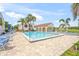 Community pool area featuring lounge chairs and palm trees, perfect for relaxation and leisure at 810 Capri Isles Blvd # 230, Venice, FL 34292