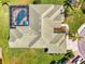 Aerial view of a home showcasing a screened pool, lush landscaping, and a well-maintained tile roof at 854 Blue Crane Dr, Venice, FL 34285