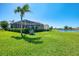 Spacious backyard offers a manicured lawn, lake and golf course views at 854 Blue Crane Dr, Venice, FL 34285