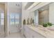 Bright bathroom features white cabinets, granite countertops, and a window view at 854 Blue Crane Dr, Venice, FL 34285