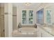 Elegant bathroom featuring a garden tub, plantation shutters, and high-end finishes at 854 Blue Crane Dr, Venice, FL 34285