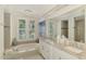 Luxurious bathroom featuring a soaking tub, dual sinks, and modern fixtures at 854 Blue Crane Dr, Venice, FL 34285
