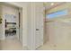 Well lit bathroom with glass shower enclosure and entry to hall at 854 Blue Crane Dr, Venice, FL 34285
