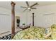 Bright bedroom features a tropical bedspread, decorative posts and ceiling fan at 854 Blue Crane Dr, Venice, FL 34285