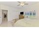 This bedroom has a flat screen television, a ceiling fan and a bright window at 854 Blue Crane Dr, Venice, FL 34285