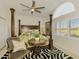 Brightly lit bedroom featuring tropical theme and a ceiling fan at 854 Blue Crane Dr, Venice, FL 34285