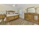 Bedroom with a wooden bed frame, a large window and a decorative rug at 854 Blue Crane Dr, Venice, FL 34285
