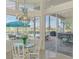 Inviting breakfast nook with glass table, view of patio, and unique chandelier at 854 Blue Crane Dr, Venice, FL 34285