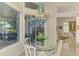 Cozy breakfast nook with glass table, view of patio, and unique chandelier at 854 Blue Crane Dr, Venice, FL 34285