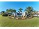Club sign at Pelican Pointe with lush landscaping, decorative rocks and manicured lawn at 854 Blue Crane Dr, Venice, FL 34285