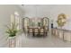 Elegant dining room featuring a large table with seating for ten, a chandelier, and stylish cabinetry at 854 Blue Crane Dr, Venice, FL 34285