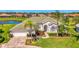 Inviting home with a well-manicured lawn, mature palm trees, and lush landscaping creates a picturesque curb appeal at 854 Blue Crane Dr, Venice, FL 34285
