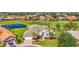 Stunning home on golf course with water view, features a lush green lawn, mature trees, and a circular driveway at 854 Blue Crane Dr, Venice, FL 34285