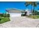 Beautiful home with a well-maintained lawn, lush landscaping, and a spacious driveway at 854 Blue Crane Dr, Venice, FL 34285