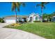 Stunning home with lush green lawn, mature trees, and great curb appeal in quiet residential neighborhood at 854 Blue Crane Dr, Venice, FL 34285
