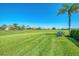 Picture of a vibrant golf course with palm trees and well-manicured lawns, complemented by upscale residences at 854 Blue Crane Dr, Venice, FL 34285