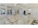 Open floor plan kitchen with white cabinetry, stainless appliances, granite counters, and an eat-in dining nook at 854 Blue Crane Dr, Venice, FL 34285
