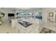 Open-concept kitchen with white cabinets, granite countertops, stainless appliances, and seamless access to the outdoors at 854 Blue Crane Dr, Venice, FL 34285