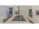 Chef's kitchen featuring granite countertops, stainless appliances, custom cabinetry, and island with cooktop at 854 Blue Crane Dr, Venice, FL 34285