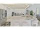Kitchen featuring an island with breakfast bar seating, granite countertops, white cabinets, and stainless steel appliances at 854 Blue Crane Dr, Venice, FL 34285