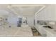 All-white kitchen with granite counters, stainless steel appliances, and an eat-in nook with floral runner rug at 854 Blue Crane Dr, Venice, FL 34285
