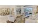 Spacious living room seamlessly connects to the dining area and offers a view of the outdoor pool and patio at 854 Blue Crane Dr, Venice, FL 34285