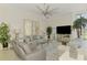 Spacious living room featuring neutral decor, ample seating, and a modern ceiling fan at 854 Blue Crane Dr, Venice, FL 34285