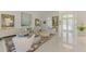 Sophisticated living room showcasing chic furniture, tile floors, and artful decor with adjacent front entry at 854 Blue Crane Dr, Venice, FL 34285
